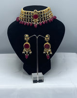 Choker style gold plated Kundan set with ruby coloured moti adorned with ruby colour stone and comes with matching earrings