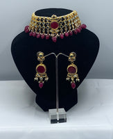 Choker style gold plated Kundan set with ruby coloured moti adorned with ruby colour stone and comes with matching earrings