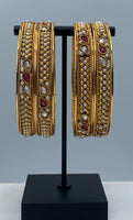 Oxidized Gold plated bangles adorned with ruby and white stones with moti work