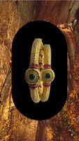 Gold plated bangles adorned with ruby and emerald stones with screw lock