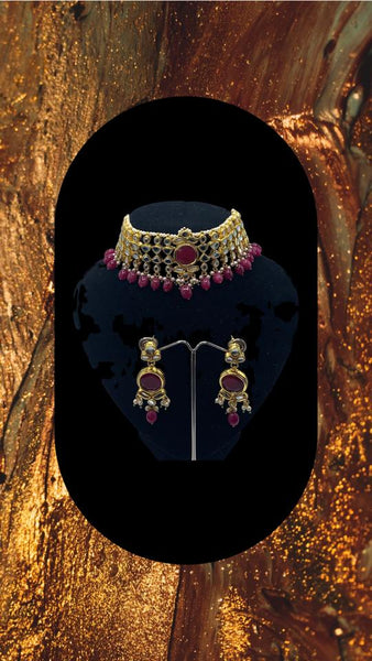 Choker style gold plated Kundan set with ruby coloured moti adorned with ruby colour stone and comes with matching earrings