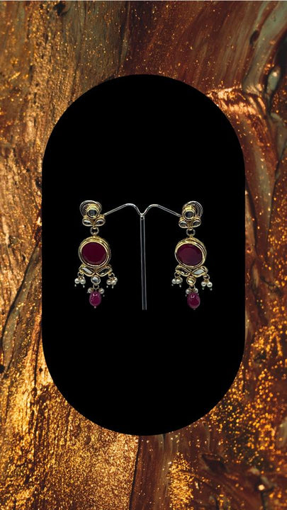 Choker style gold plated Kundan set with ruby coloured moti adorned with ruby colour stone and comes with matching earrings