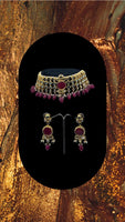 Choker style gold plated Kundan set with ruby coloured moti adorned with ruby colour stone and comes with matching earrings