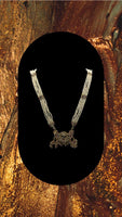 Long beaded necklace with gold plated pendant adorned with multi coloured diamonds