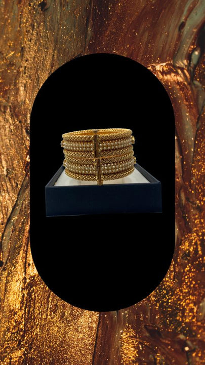 Gold plated screw lock bangle set adorned with moti and topaz colour stones