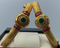 Gold plated bangles adorned with ruby and emerald stones with screw lock
