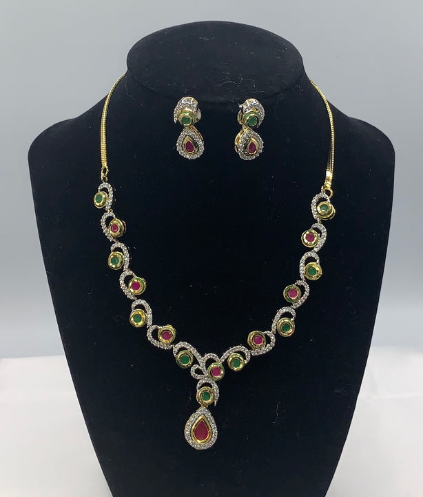 Gold plated with high quality emerald , ruby and diamond studded necklace set with matching earrings