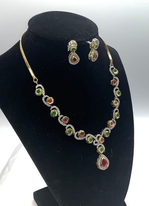 Gold plated with high quality emerald , ruby and diamond studded necklace set with matching earrings