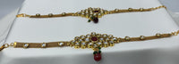 Gold plated kundan bajubandh adorned with ruby colored stone and bead