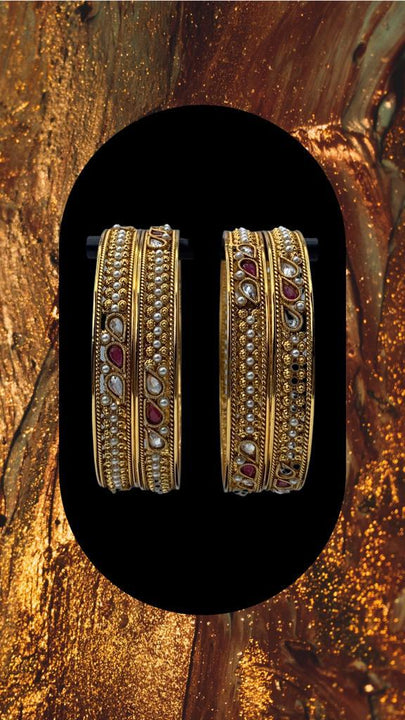 Oxidized Gold plated bangles adorned with ruby and white stones with moti work